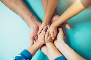 Closeup of the united hands of one family.