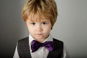 Fashionable little boy in stylish clothes & bow tie.