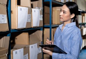 Businesswoman working with product inventory for reverse logistics