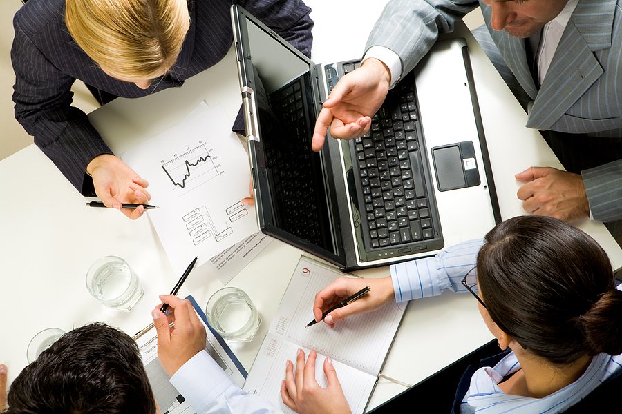 Workers discussing online sales and reviews