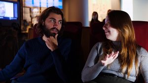 Two people giving movie critic review