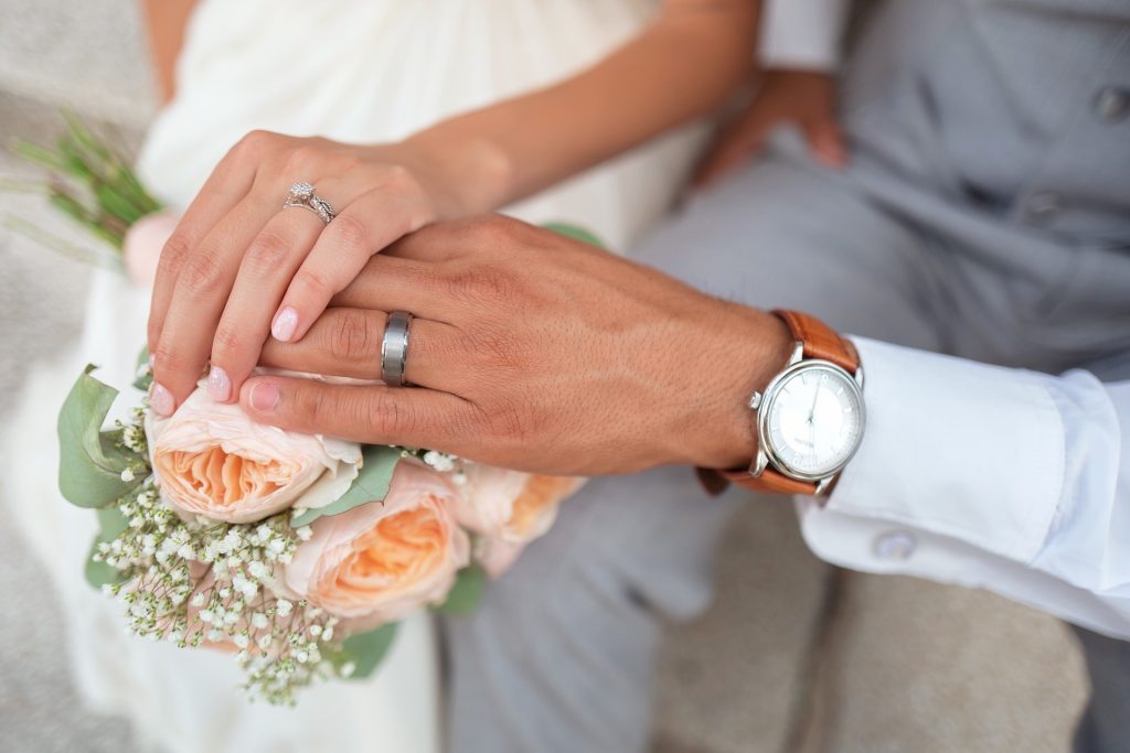Bride and groom's hands wearing their wedding ring