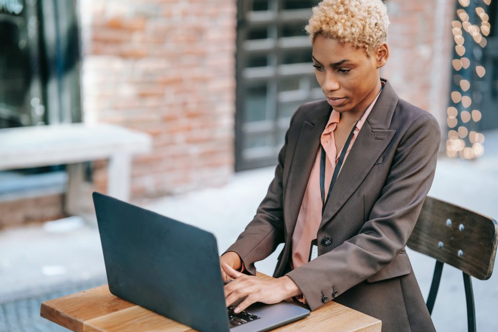 Woman writing customer review on her laptop