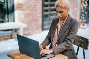 Woman writing customer review on her laptop