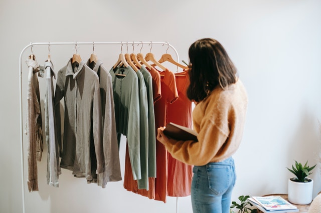 A woman looking through her summer wardrobe upgrade.